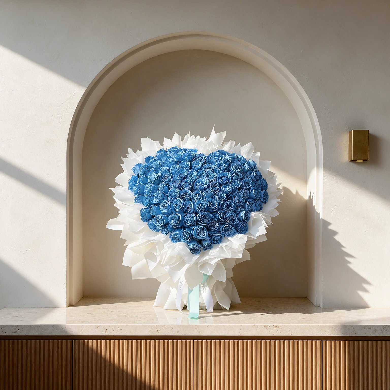 Heart-shaped bouquet of 100 blue roses wrapped in elegant white paper